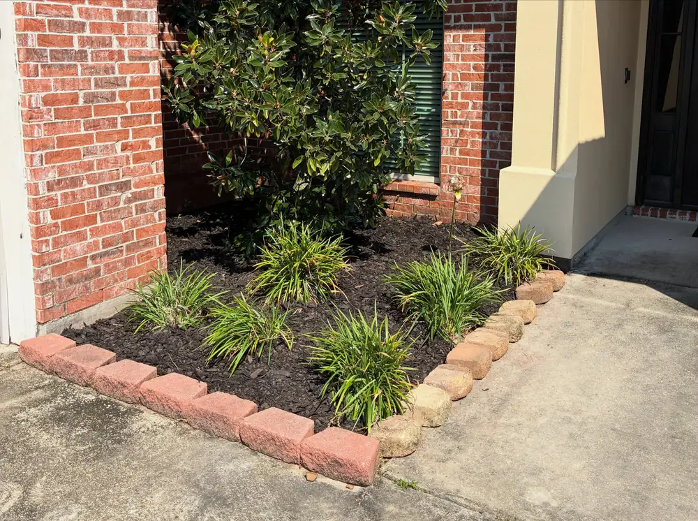 Planted bed with brick border at a front entrance
